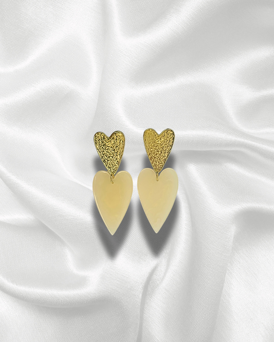 Calypso | Boucles d’oreilles dorées avec cœurs pendants